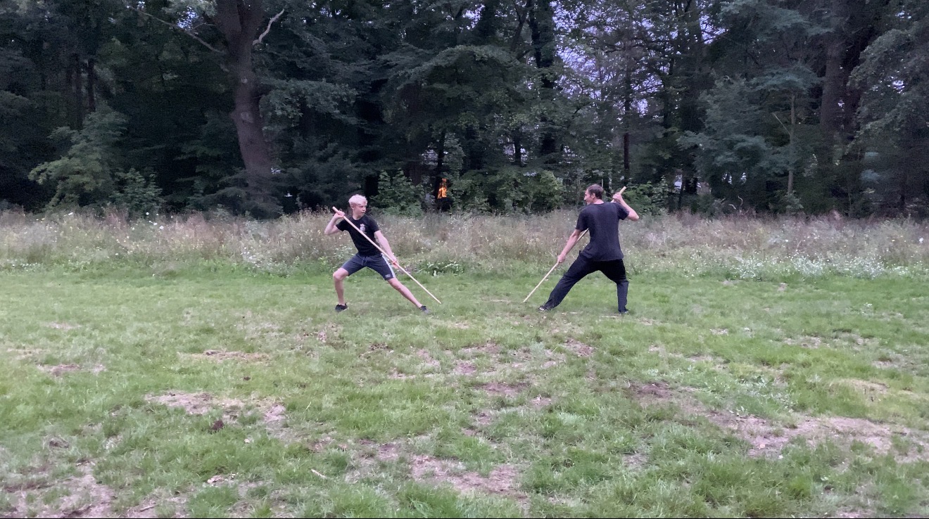 Two practitioners doing a staff drill